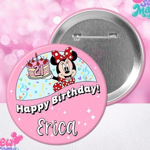 May include: A round pink pinback button featuring a graphic of Minnie Mouse holding a birthday cake with the number 21 on it. The text Happy Birthday and the name Erica are printed on the front. The back shows a silver metal pin mechanism.