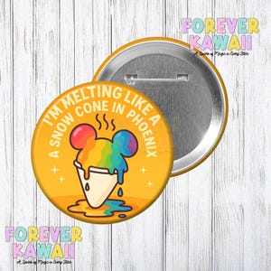 May include: A yellow button with the text "I'M MELTING LIKE A SNOW CONE IN PHOENIX" and a colorful snow cone illustration. The button has a pin back and the words "FOREVER KAWAII" are in the background.