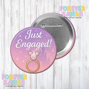 May include: A circular badge with the words "Just Engaged!" in white, set against a purple and pink gradient. The design features a Mickey Mouse ring and a castle silhouette. The badge has a silver back, with "Forever Kawaii" at the top and bottom.