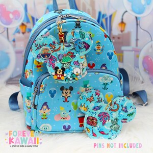 May include: A light blue backpack with a Mickey Mouse theme, featuring various Disney characters and designs. The backpack has a front pocket and a top handle. Two Mickey Mouse-shaped keychains are included. The text "Forever Kawaii" and "Pins Not Included" are visible.