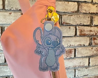 Shrug Stitch Snap Tab Keychain – Pastel Disney Bag Charm with Bow – Kawaii Stitch Keychain – Lilo & Stitch Zipper Pull – Handmade Vinyl Acce