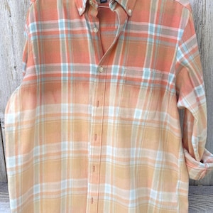 May include: Orange and white plaid button-down shirt with a faded ombre effect. The shirt has a button-down collar, a chest pocket, and long sleeves. The brand name "Club Room" is visible on the label.