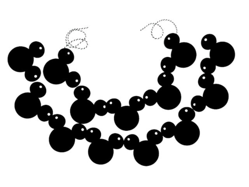 May include: A black and white garland of circles strung together with a thin white string. The circles are arranged in a pattern that resembles a chain.