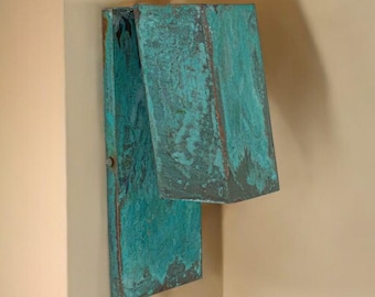 May include: A teal blue wooden box with a hinged lid, mounted on a wall.