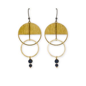 May include: A pair of gold-toned earrings with a unique design. Each earring features a half-circle top, a large circular hoop, and two small, dark blue beads hanging at the bottom. The earrings have a modern, geometric aesthetic.