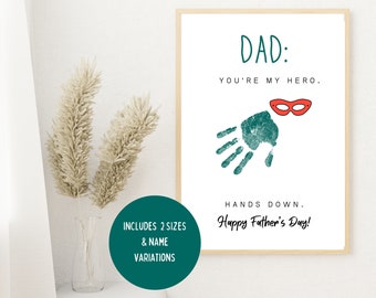 Pode incluir: Cartão do Dia dos Pais imprimível com uma impressão de mão verde e uma máscara vermelha. O texto diz "DAD: YOU'RE MY HERO. HANDS DOWN. Happy Father's Day!"  Inclui 2 tamanhos e variações de nome.