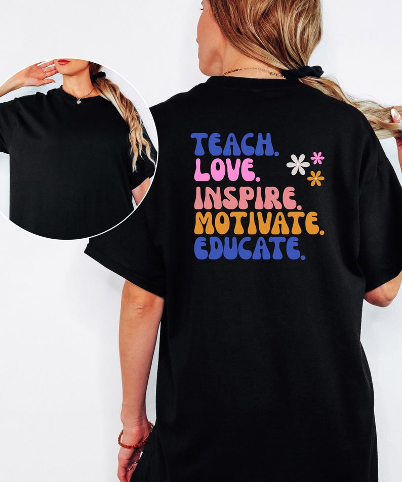 May include: Black t-shirt with the words "TEACH. LOVE. INSPIRE. MOTIVATE. EDUCATE." in a colorful, retro font. Two small flower graphics are next to the text. The shirt is a crew neck and has short sleeves.