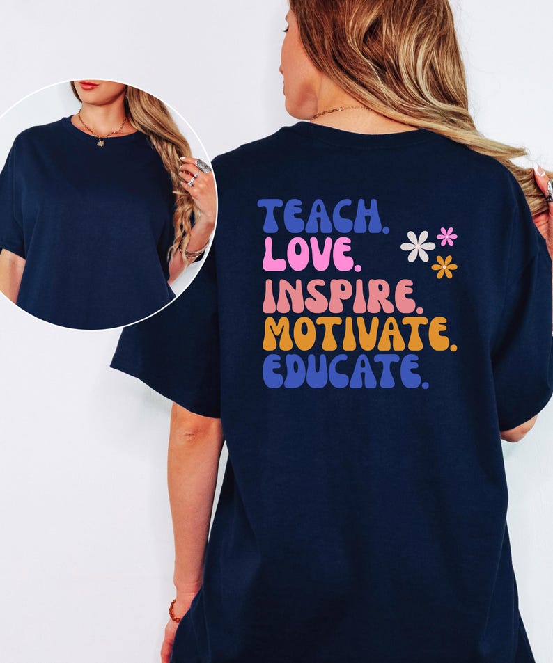 May include: Navy blue t-shirt with the words "TEACH. LOVE. INSPIRE. MOTIVATE. EDUCATE." in a retro font. The back of the shirt also features two small flower graphics. A casual, comfortable tee for teachers.