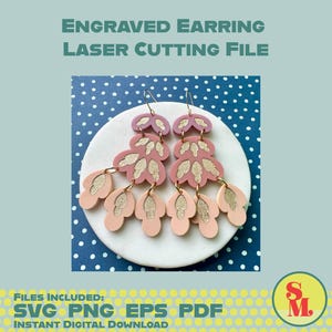 May include: A pair of pink and gold earrings with a layered floral design, displayed on a white circular surface against a blue background with white polka dots. The image includes text that reads "Engraved Earring Laser Cutting File."