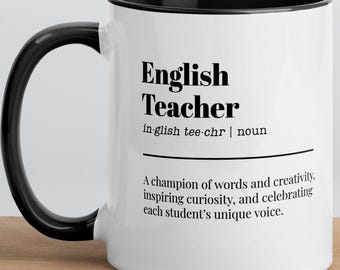 May include: White ceramic mug with a black interior and handle. The mug features the text "English Teacher" with a definition and a quote about inspiring students. The mug is on a wooden surface.