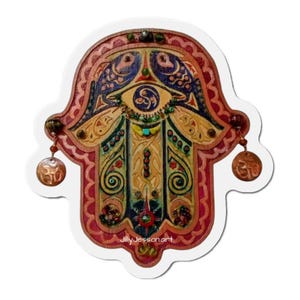 May include: A decorative Hamsa hand sticker with intricate details. The design features a central eye motif, floral patterns, and dangling charms. The color palette includes shades of red, gold, blue, and green, with the text "jillyjessonart" at the bottom.