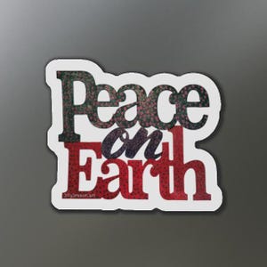 May include: White sticker with the text "Peace on Earth" in black and red lettering with a floral pattern. The text "JillyDresson.art" is in the bottom left corner.