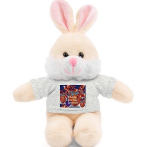 May include: A plush bunny wearing a grey t-shirt with a colorful graphic that says "Love is the Answer".