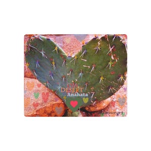 May include: A heart-shaped cactus pad with sharp spines, set against a textured background. The image includes the words "OM DESERT Anahata" and a heart graphic. The cactus is green, and the background is a mix of brown and pink.