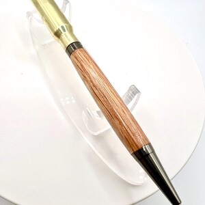 308 caliber shell casing with Gun metal fittings and Red Oak wood.