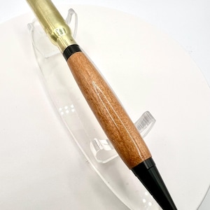308 shell casing twist pen with black fittings and Cherry wood. Casing is used!