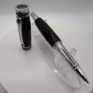 A majestic Rollerball pen with chrome fittings and Red and black acrylic barrel and a small stone in the clip.