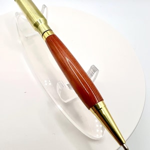 308 caliber shell casing twist pen with gold fittings and Cedar wood.