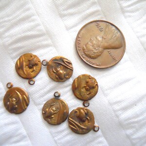 May include: Seven antique bronze charms with a frog design. Each charm has a loop for attaching to a necklace or bracelet.