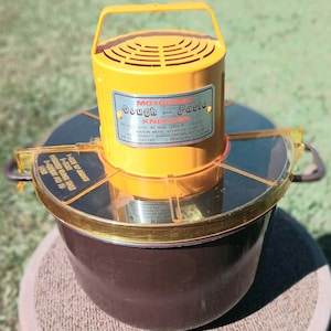 May include: A vintage yellow Motorized Dough and Pasta Kneader with a handle, a clear lid, and a brown base. The label reads "Motorized Dough and Pasta Kneader". The appliance is designed for mixing dough and pasta.