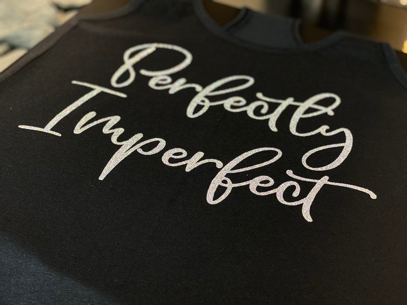 May include: Black tank top with the text "Perfectly Imperfect" in silver glitter lettering.