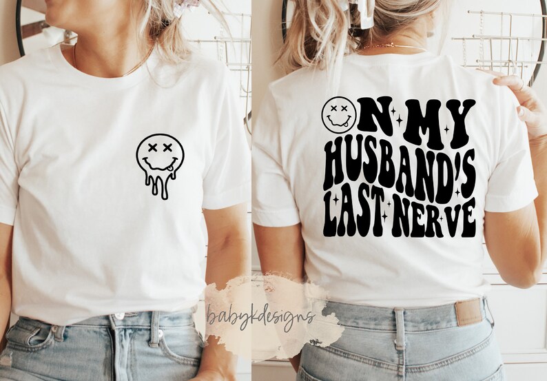 May include: White t-shirt with a dripping smiley face on the front and the text "On my husband's last nerve" on the back.