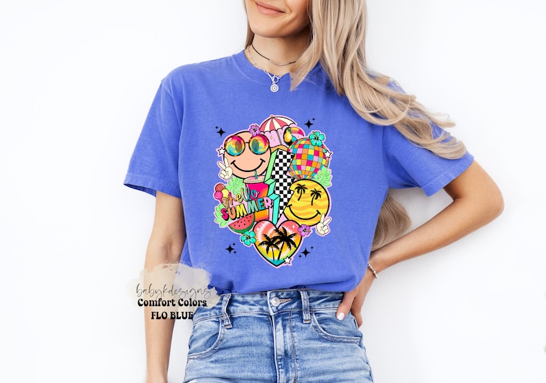 May include: A blue Comfort Colors t-shirt with a vibrant graphic of smiley faces, a disco ball, and the words "Hello Summer!". The design includes a watermelon slice, peace signs, and a heart with palm trees. The shirt is a Flo Blue colour.