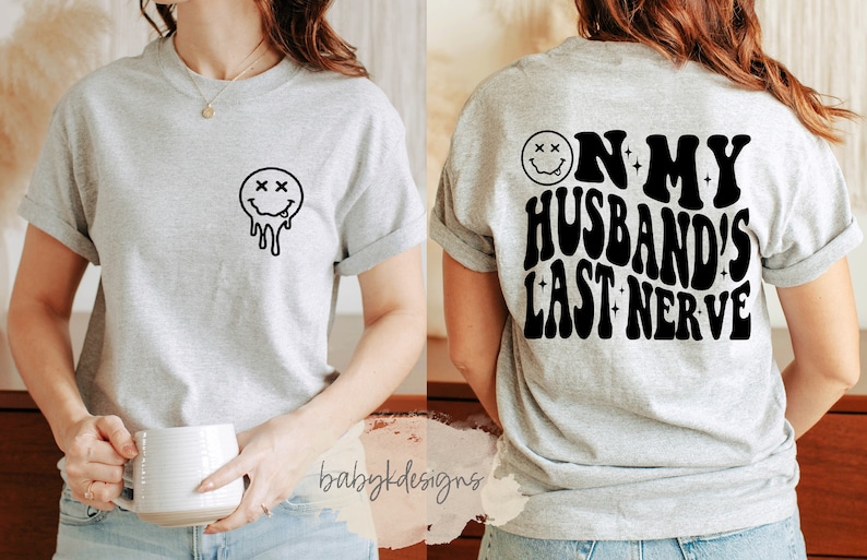 May include: Gray t-shirt with a dripping smiley face on the front and the text "On my husband's last nerve" on the back.