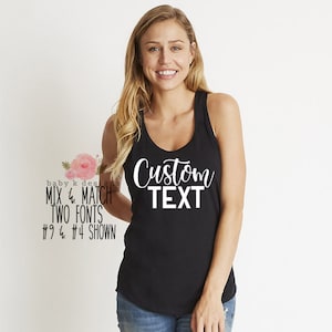 May include: A black tank top with the text "Custom Text" printed in white on the front. The tank top is being modeled by a person with long blonde hair.