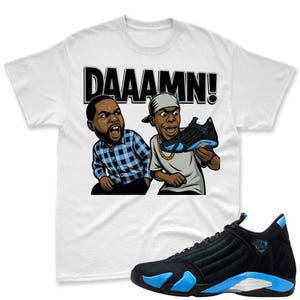 May include: White t-shirt with a cartoon graphic of two men exclaiming "DAAAMN!" and holding a black and blue sneaker. A black and blue sneaker is also displayed below the shirt.