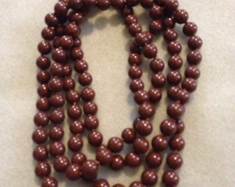 Brown beaded and knotted retro vintage necklace - approximately 46" in length