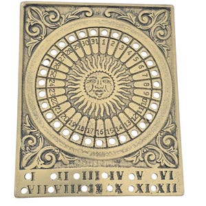 May include: A rectangular, antique brass-colored calendar with a circular dial featuring numbers 1-31 and a sun face in the center. Roman numerals I-XII are at the bottom, with ornate scrollwork.