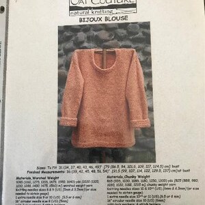 May include: A knitting pattern for a Bijoux Blouse from Oat Couture. The pattern includes instructions for sizes 31 to 49 inches bust and uses worsted or chunky weight yarn. The pattern also includes gauge information and needle sizes.
