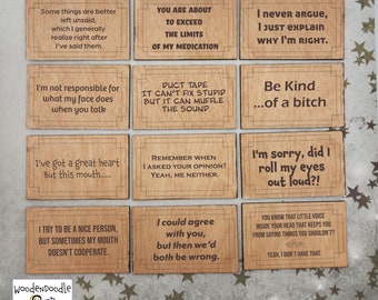 May include: A set of nine wooden signs with humorous sayings. The signs are all rectangular and have a light brown wood grain finish. The text on the signs is in a white font. The signs are arranged in a grid pattern.