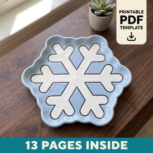 May include: A light blue ceramic dish shaped like a snowflake with a white snowflake design in the center. The text PRINTABLE PDF TEMPLATE and 13 PAGES INSIDE are visible on the image, indicating a digital file for a craft project.