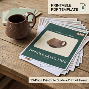 May include: A brown textured ceramic mug with a handle sits next to a stack of printed paper guides. The top page features the text "PRINTABLE PDF TEMPLATE," "DIY Pottery Template," "GAIA POTTERY," and "DOUBLE LEVEL MUG" with an image of the mug.