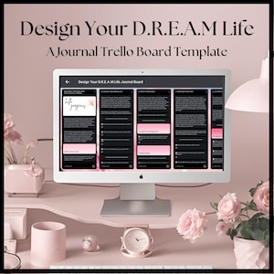 May include: A computer screen displaying a journal Trello board template titled "Design Your D.R.E.A.M Life". The template is divided into five sections, each with a different question related to achieving one's dreams. The screen is on a pink surface with a pink vase of flowers and a pink clock.