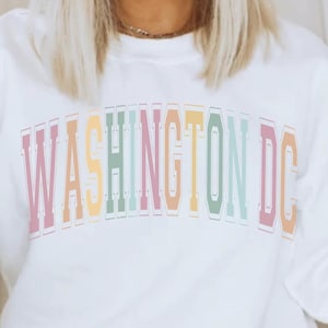 May include: White sweatshirt with a rainbow colored "WASHINGTON DC" graphic.