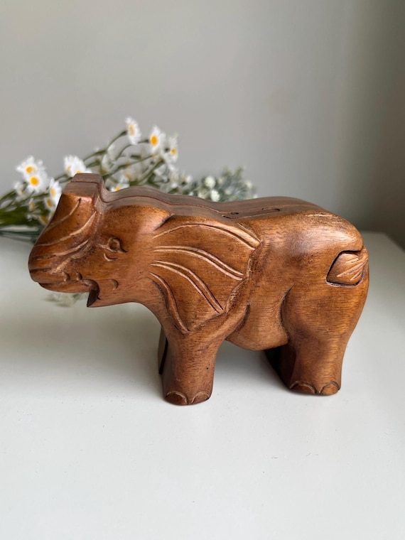 A hand-carved wooden elephant that doubles as a secret-compartment puzzle box — you have to figure out the hidden mechanism to unlock it.