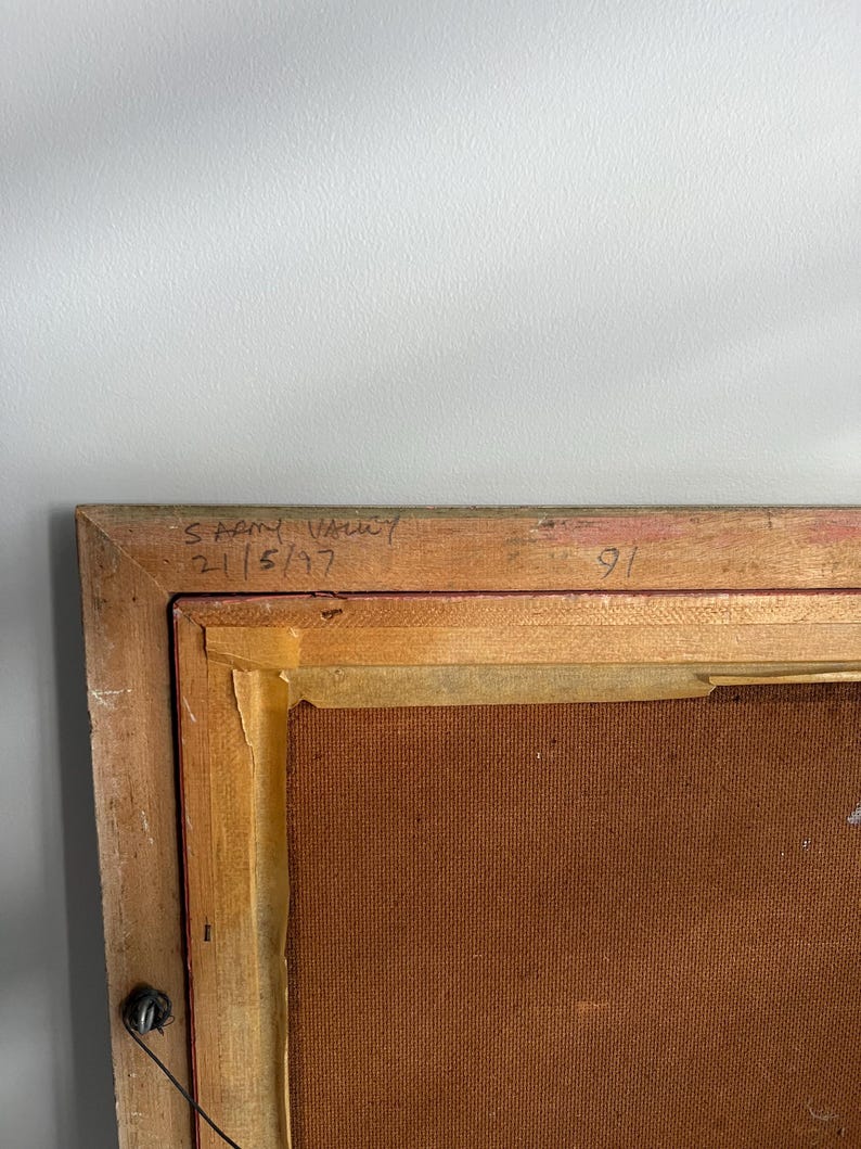 May include: A framed artwork with a wooden frame. The upper left corner of the frame has handwritten text that reads "SARNY VALLEY 2/5/97". The number "91" is written on the top right corner of the frame.