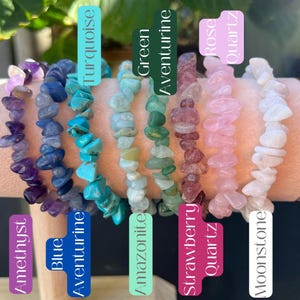 May include: A collection of gemstone chip bracelets in various colors, including amethyst, blue aventurine, turquoise, amazonite, green aventurine, strawberry quartz, rose quartz, and moonstone. Each bracelet is labeled with its corresponding gemstone name.