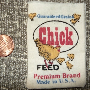 May include: A vintage bag of chick feed with a yellow chick and the text "Guaranteed Grains Chick Feed Premium Brand Made in U.S.A."