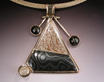 Mokume Gane Psilomelane Pendant in 18 karat Gold with Star Diopsides and Rutilated Quartz MOUNT SAINT HELENS