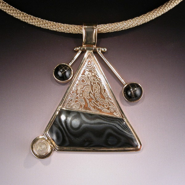 Mokume Gane Psilomelane Pendant in 18 karat Gold with Star Diopsides and Rutilated Quartz MOUNT SAINT HELENS