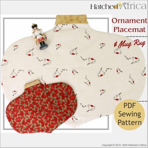 May include: A cream-colored ornament placemat and mug rug with a bird pattern. The placemat has a gold trim and a smaller red mug rug with a holly design. A PDF sewing pattern is available.