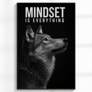 May include: Black and white framed print featuring a wolf's head with the text "MINDSET IS EVERYTHING". The wolf is depicted in detail, with a focus on its fur and facial features. The print is displayed on a white wall.