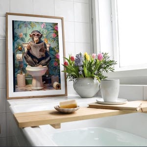 May include: A framed wall art print featuring a chimpanzee wearing pink sunglasses while sitting on a toilet and reading a newspaper titled The Daily Flush, set against a vibrant floral wallpaper background with rolls of toilet paper.