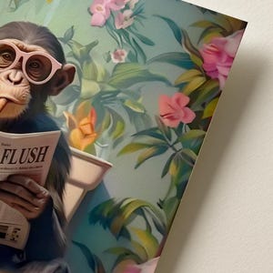 May include: A chimpanzee wearing light pink glasses sits on a toilet while reading a newspaper with the word FLUSH printed on the front page. The background features a vibrant botanical scene filled with green leaves and pink flowers.