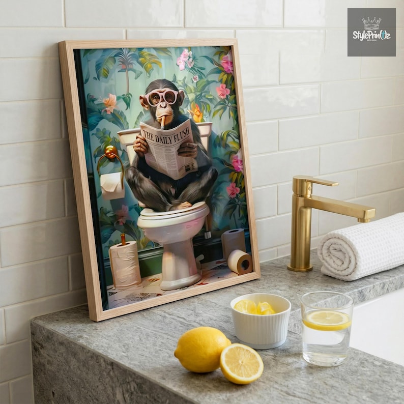 May include: A framed wall art print featuring a chimpanzee wearing pink glasses, sitting on a toilet, and reading a newspaper titled The Daily Flush. The background shows a vibrant tropical floral wallpaper with pink and orange flowers and green leaves.