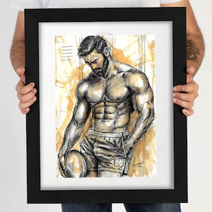 May include: A framed art print featuring a charcoal and ink sketch of a muscular, bearded individual wearing athletic shorts and holding a round object. The artwork is set against a light tan, watercolor-style background with visible locker lines.